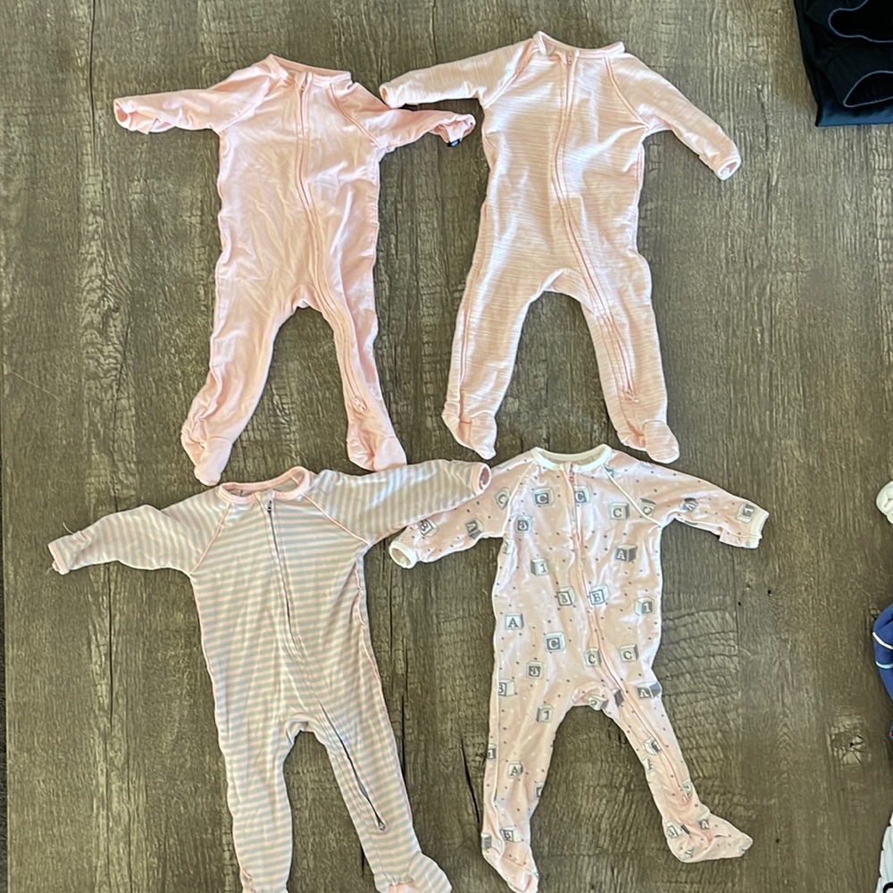 4 pairs of Sweet Bamboo newborn 2-way zipper footies with handcuffs.